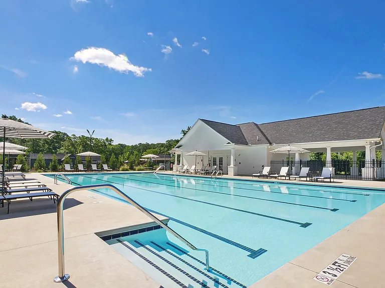 Poolside oasis featuring chic and comfortable seating.