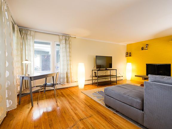 Living room with a working gas fireplace and view of Lake Union.