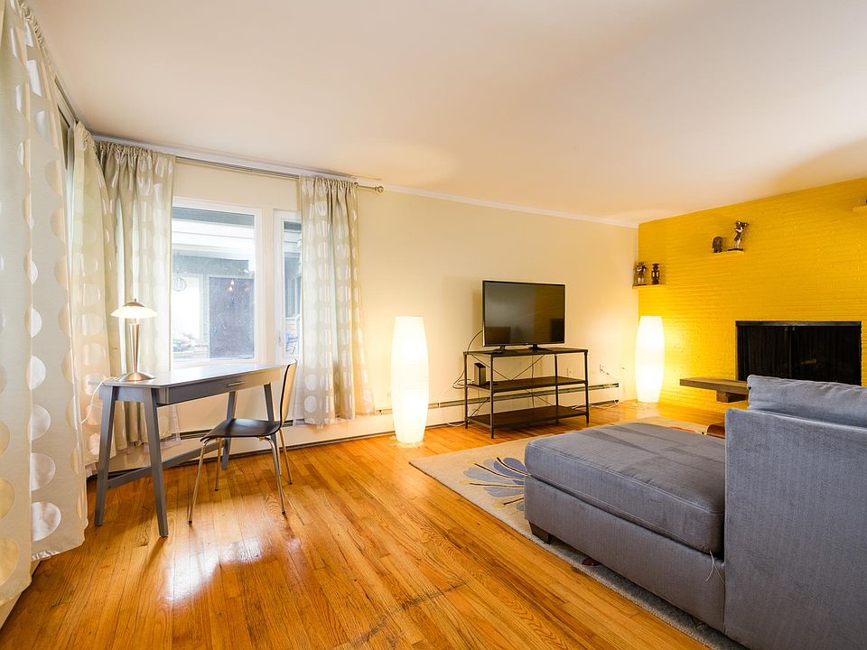 Living room with a working gas fireplace and view of Lake Union.