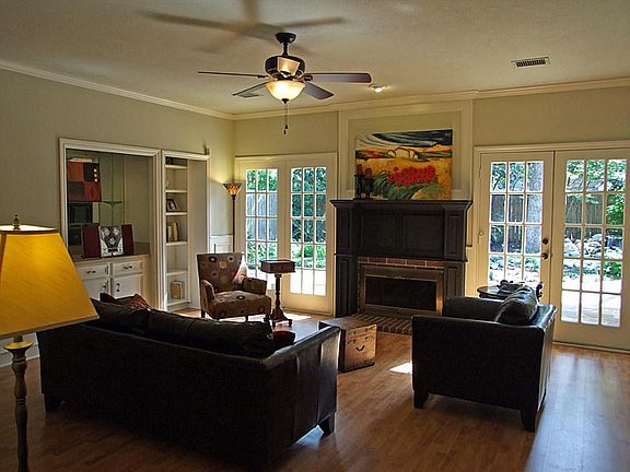 Fireplace, upgraded ceiling fans, double doors to tranquil backyard.