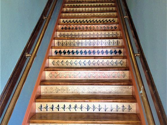 Handpainted stairs greet you at the entrance.