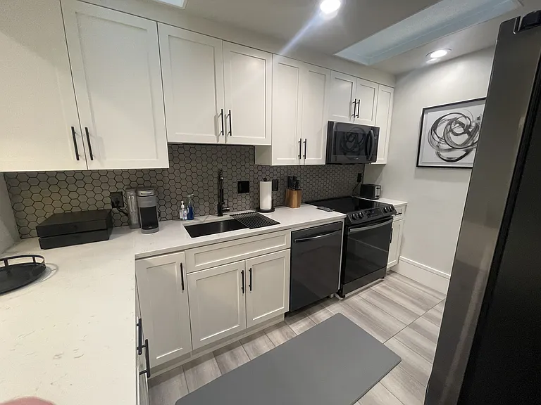 Full size refrigerator, electric stove, microwave, dishwasher, and fully stocked kitchen with pots and pans, dishes & utensils
