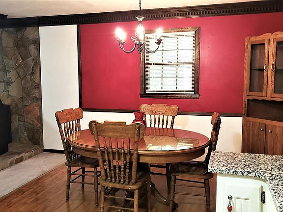 The dining area is open to the kitchen and living room making this a cool hub of the home space. The sunroom is to the right in this photo.