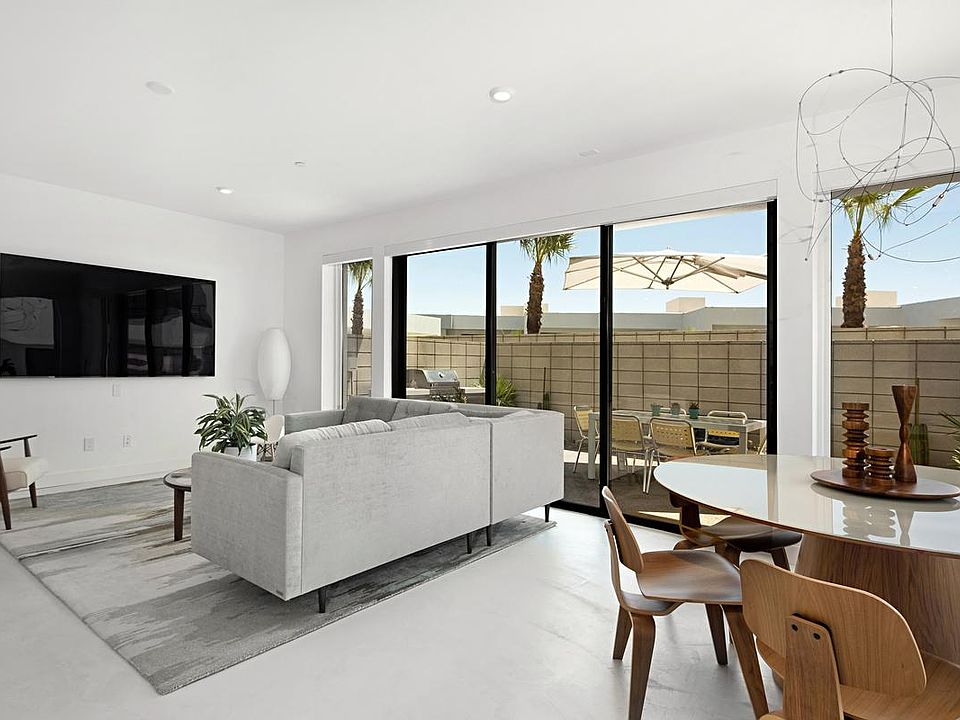 Large open interior living space. Sliders open to outdoor living space w/built in barbecue, beverage refrigerator, dining and fountain.