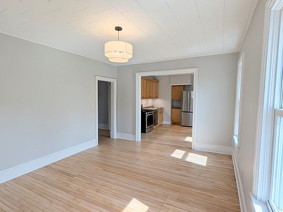 Light and airy rooms feature newly refinished hardwood floors thoughout. Living room opens on to the private 10 ft x 30 ft porch with newly installed composite decking.