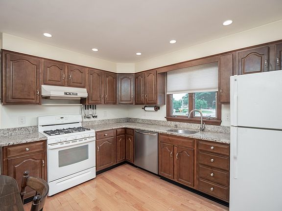 Gas stove for cooking and the beautiful hardwood flooring continues in this room.