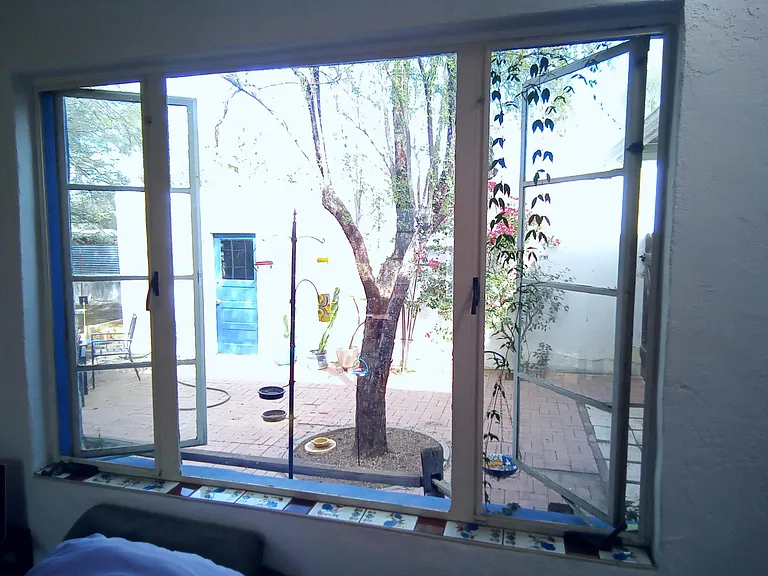 View of courtyard through master bedroom window