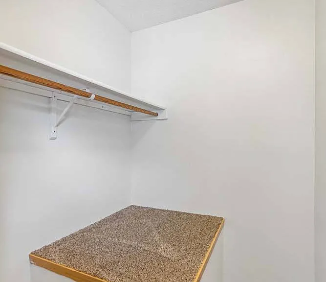 A spacious walk-in closet with built-in shelving keeps your wardrobe organized and everyday essentials within easy reach.