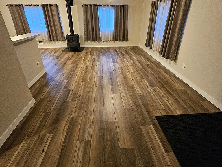 Front entrance, living room, kitchen bar, and propane stove (without furniture)