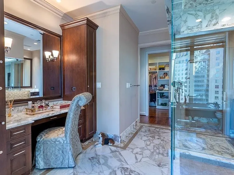 Primary Bath boasts a make-up table, jetted tub, & two water closets.