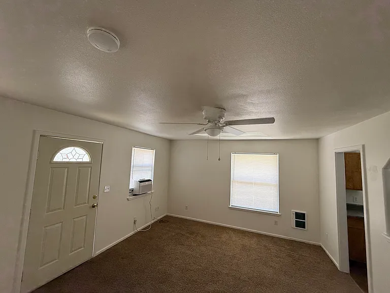 Front room, new fan/light, electric heater, kitchen entry to the right with open pass through