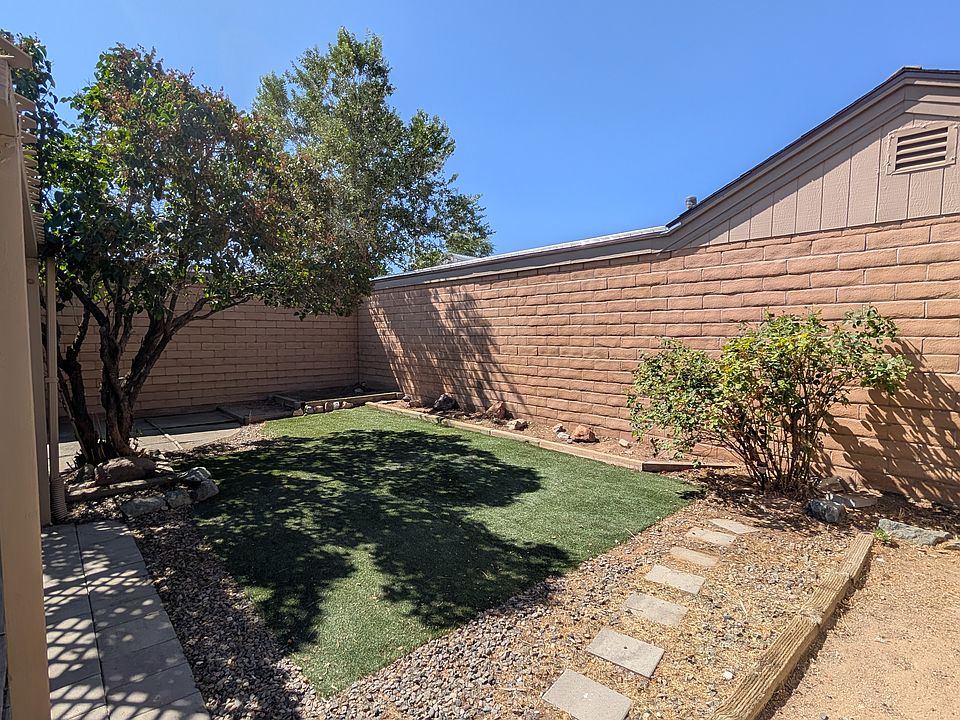 Private, quite and shady backyard with low maintenance artificial grass. Beautiful lialac tree and rose bush. Defined area for planting a vegie garden if desired.