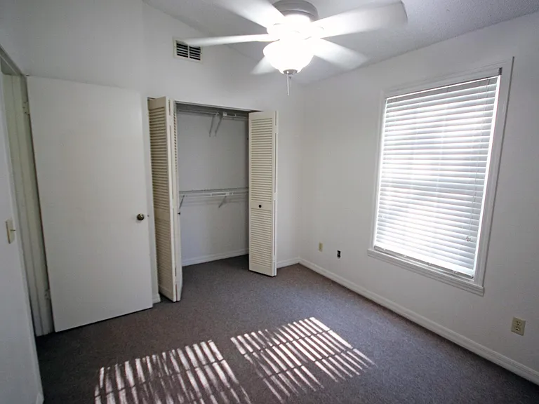 Rear upstairs Bedroom with large closet & ceiling fan.