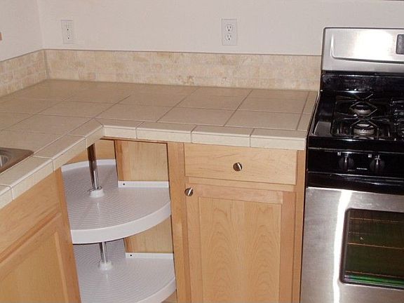 Tile counters & backsplash, lazy susan, gas stove, upgraded Stainless Appliances.