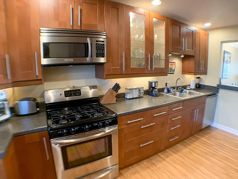 Fully updated with dishwasher, garbage disposal, microwave, gas stove, and under-cabinet lighting.