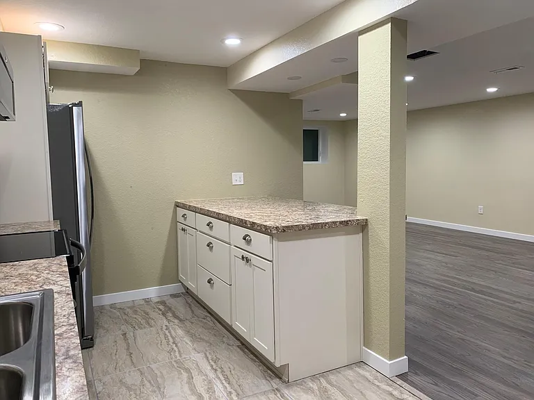 Island with overhang into the living/dining area which can fit 3-4 barstools for additional seating. This open concept areas is great for keeping people connected. The island futures deep drawers for pots and pans or all those plastic containers you neve