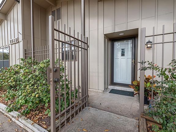 As you make your way along the lushly landscaped path, you are greeted by a beautiful solid wood door behind a sleek etched glass storm door. The entrance is protected from our occasional bad weather by this covered front porch with a decorative rail