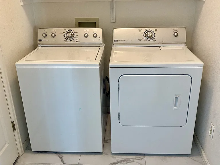 Laundry room off the kitchen is convenient and functional.