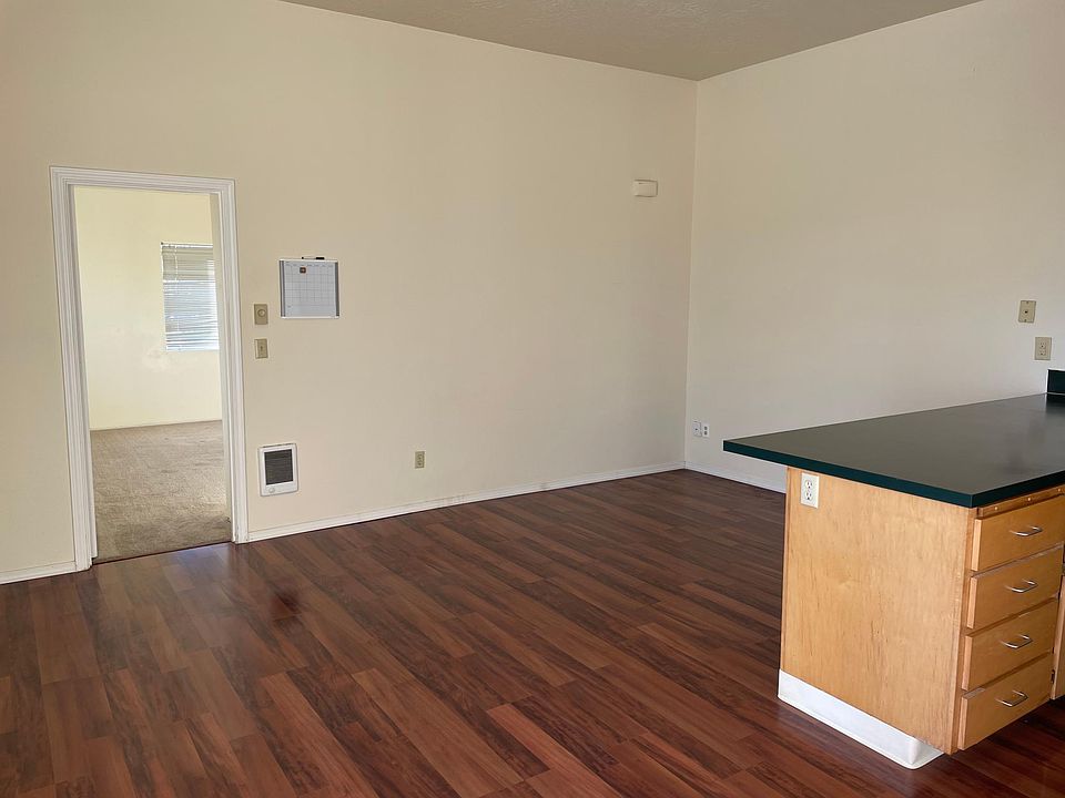 Living room and kitchen counter with view to bedroom.