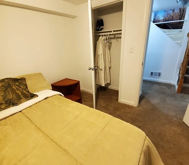 Private basement bedroom with closet and direct access to living area _ quiet and functional.
