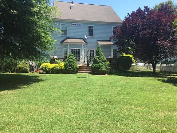 Large fenced in backyard with plenty of trees for shade and privacy