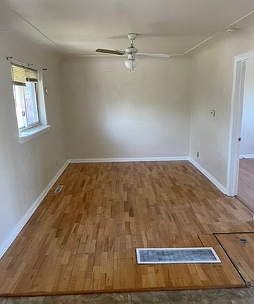 LIVING AREA WITH LAMINATE WOOD FLOORS. NEXT ONE IS THEKITCHEN OPEN AREA.