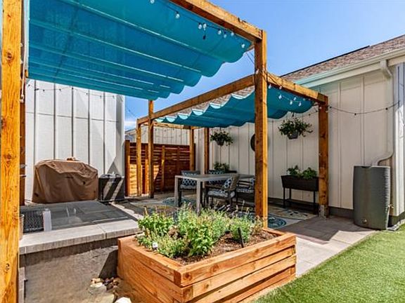 Shaded backyard oasis with xeriscaped landscaping.