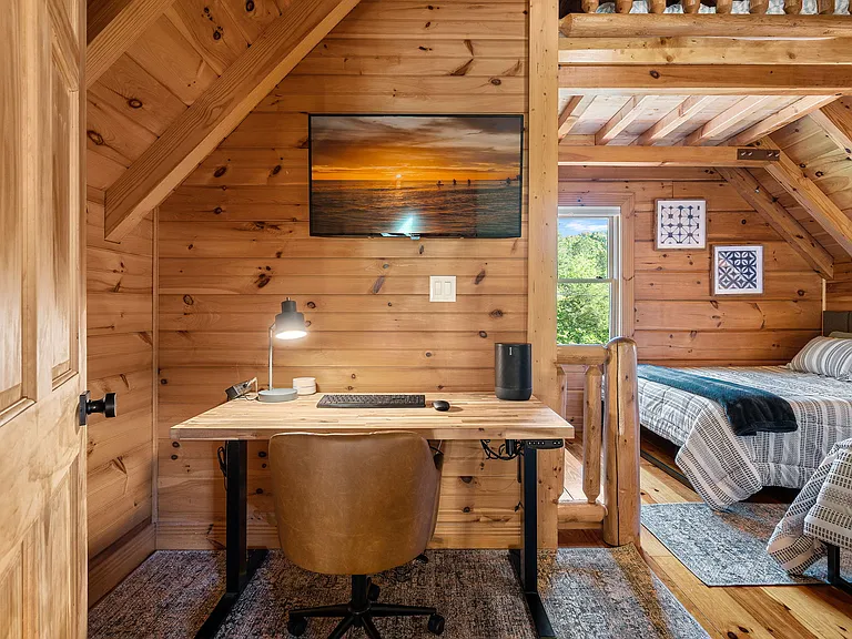 Upstairs bedroom with two queen beds and work space.