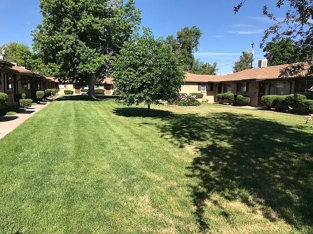 Beautiful large lawn, trees, and gardens outside every unit'
