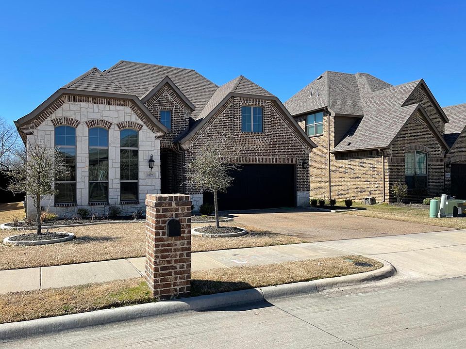 House front with flower beds