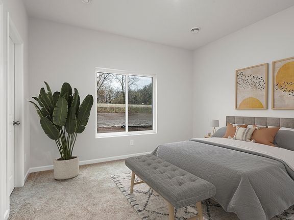 The master bedroom has enough space for a large bed and side tables.
