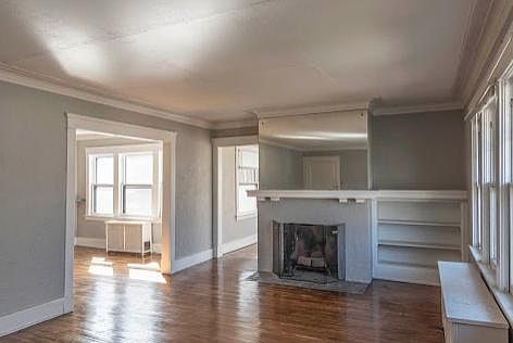 View of living room, with dining room to the left and sunroom in center.