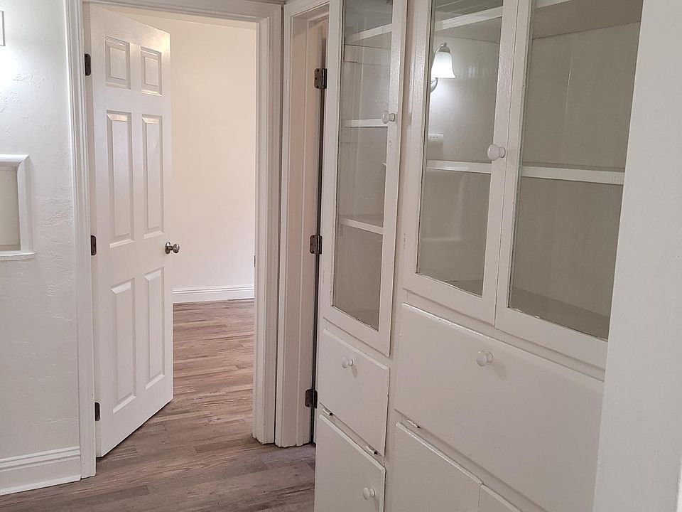 Hallway with storage hutch and view to Bedroom 3