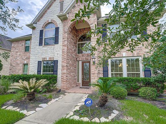 Covered entry with a 9 foot entry door and huge foyer window.