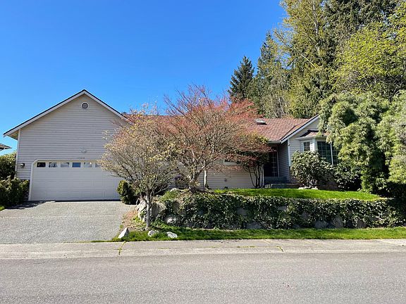 Street view of this beautiful home that sits up top a slight hill, offering quiet peace and privacy.