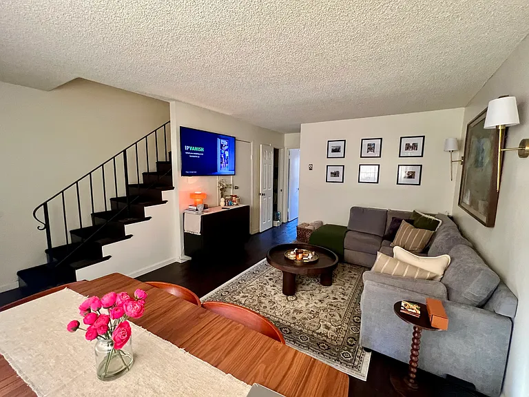 Furnished neighboring unit shown for living room layout reference