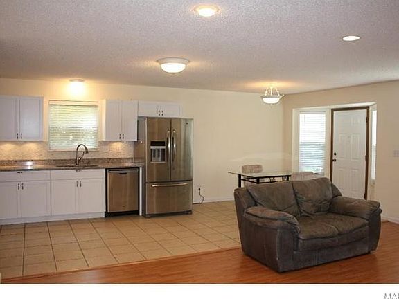 Kitchen-Breakfast room area with bay window and six panel door adjoins the family room with NEW (June 2015) wood veneer flooring, FRESH paint (June 2015) and 2" vinyl blinds.