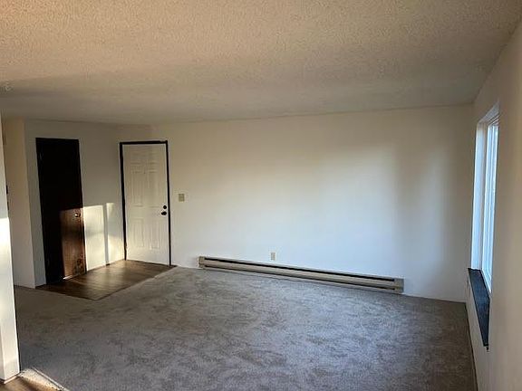 Nice sized living room with 1 year old carpet and big windows