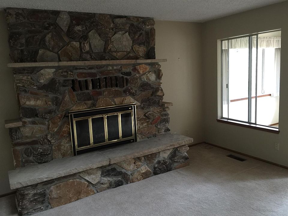 Stone Fireplace with window to sunroom
