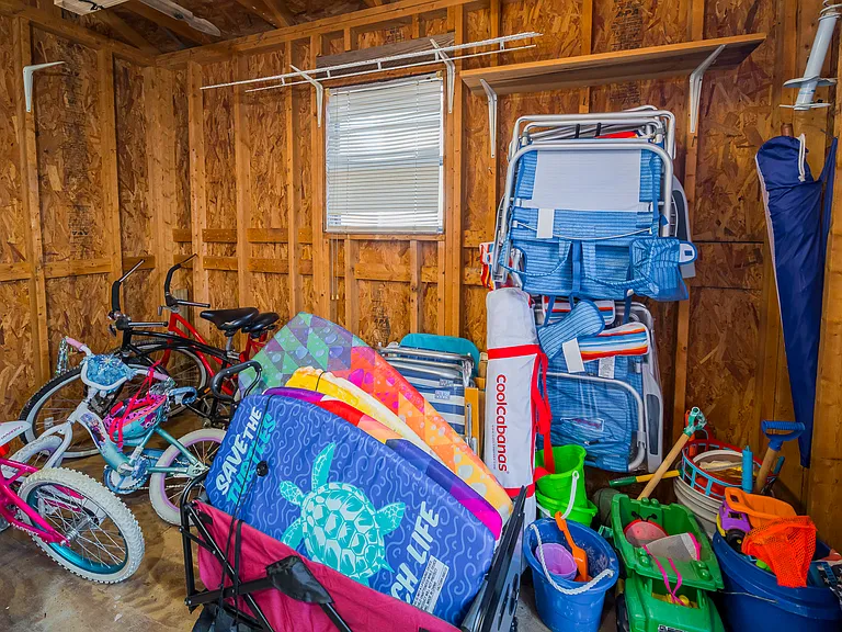 Storage Shed in Backyard has plenty of beach equipment including bicycles