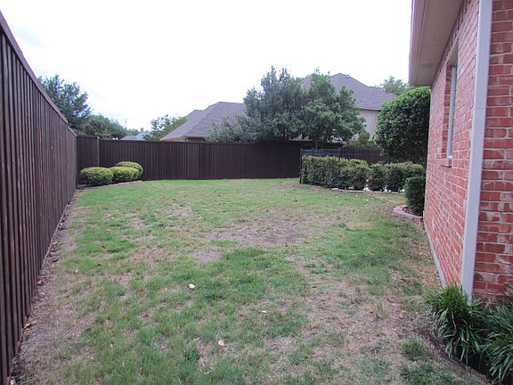 Back yard with pool fence.