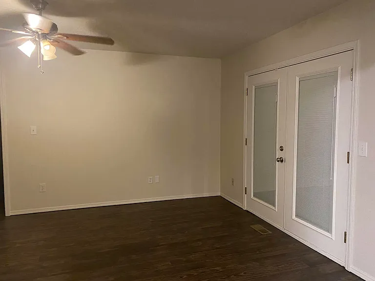 Spacious living room with patio doors that lead out to a very spacious backyard!