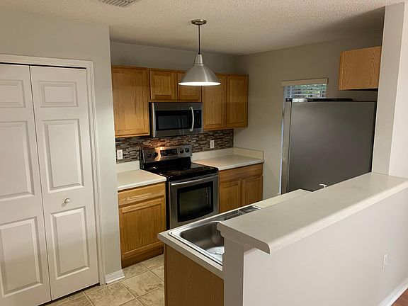 Kitchen with stainless steel appliances. Ample pantry.