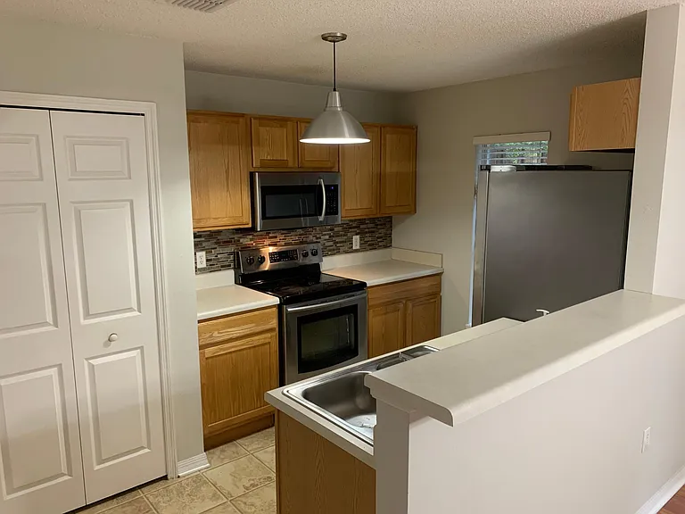 Kitchen with stainless steel appliances. Ample pantry.