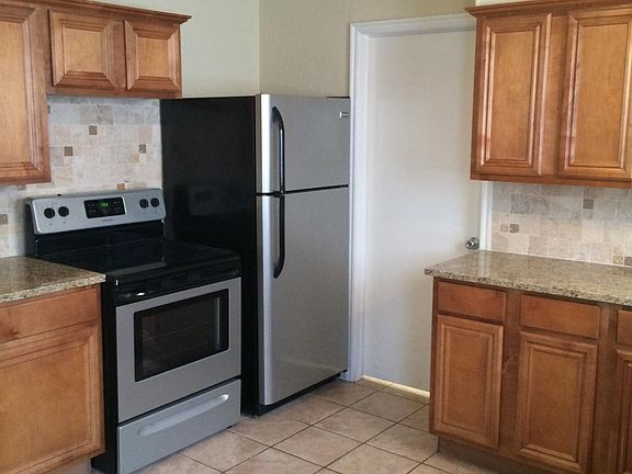 View of Kitchen with granite counter tops, custom backsplash