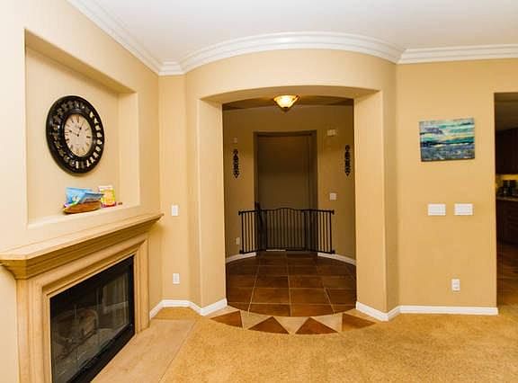 Rotunda area leading to the living room with fire place