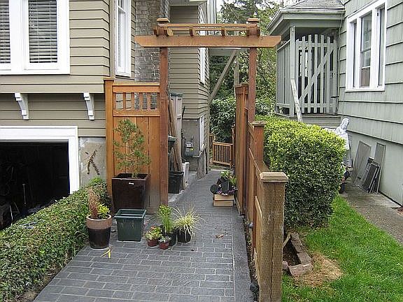 Walkway to fully fenced backyard.