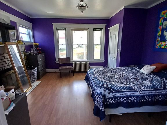 master bedroom with corner walk in closet and (non functional) aesthetic fireplace