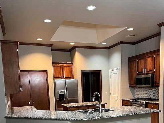 Pantry at left side t refrigerator with double doors. Counter height breakfast bar is perfect for quick meals!