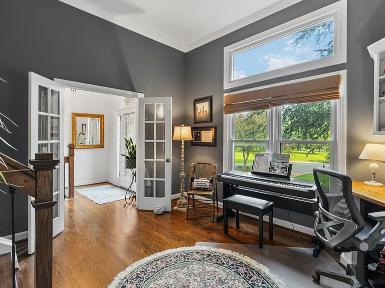 Spacious workspace with huge windows, a keyboard piano, and a dedicated workspace with an extra monitor + printer.